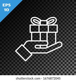 White line Gift box in hand icon isolated on transparent dark background. Merry Christmas and Happy New Year.  Vector Illustration