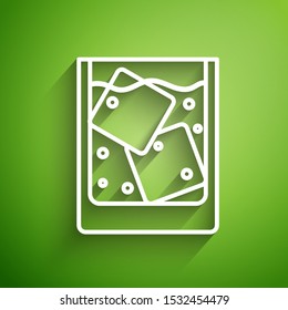 White line Glass of whiskey and ice cubes icon isolated on green background.  Vector Illustration