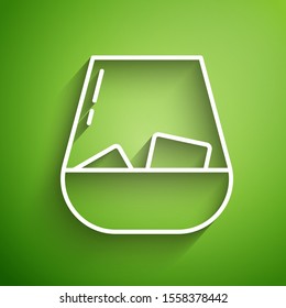 White line Glass of whiskey and ice cubes icon isolated on green background.  Vector Illustration