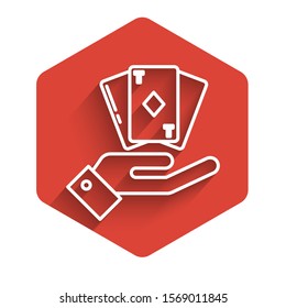 White line Hand holding deck of playing cards icon isolated with long shadow. Casino gambling. Red hexagon button. Vector Illustration