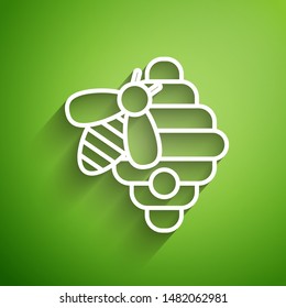 White line Hive for bees icon isolated on green background. Beehive symbol. Apiary and beekeeping. Sweet natural food.  Vector Illustration