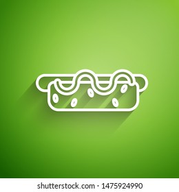 White line Hotdog sandwich with mustard icon isolated on green background. Sausage icon. Street fast food menu.  Vector Illustration