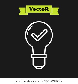 White line Light bulb and check mark icon isolated on black background. Concept of idea.  Vector Illustration