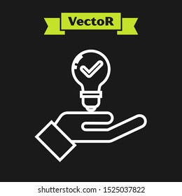 White line Light bulb in hand icon isolated on black background. Concept of idea.  Vector Illustration