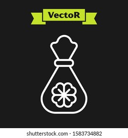 White line Money bag with four leaf clover icon isolated on black background. Cash Banking currency sign. Happy Saint Patricks day.  Vector Illustration