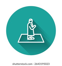 White line Muslim man prays on the carpet icon isolated with long shadow background. Green circle button. Vector