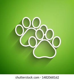 White line Paw print icon isolated on green background. Dog or cat paw print. Animal track.  Vector Illustration