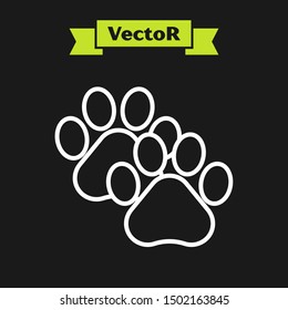 White line Paw print icon isolated on black background. Dog or cat paw print. Animal track.  Vector Illustration