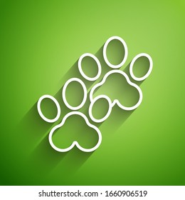 White line Paw print icon isolated on green background. Dog or cat paw print. Animal track.  Vector Illustration