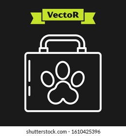 White line Pet first aid kit icon isolated on black background. Dog or cat paw print. Clinic box.  Vector Illustration