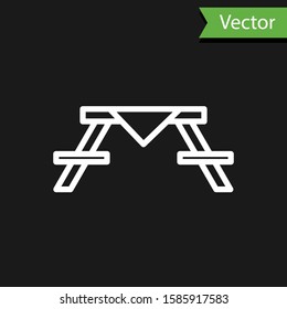 White line Picnic table with benches on either side of the table icon isolated on black background.  Vector Illustration