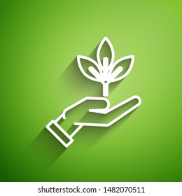 White line Plant in hand of environmental protection icon isolated on green background. Seed and seedling. Planting sapling. Ecology concept. Vector Illustration White line Plant in hand of environmental protection icon isolated on green background. Seed and seedling. Planting sapling. Ecology concept. Vector Illustration