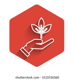 White line Plant in hand of environmental protection icon isolated with long shadow. Seed and seedling. Planting sapling. Ecology concept. Red hexagon button. Vector Illustration