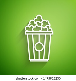 White line Popcorn in cardboard box icon isolated on green background. Popcorn bucket box.  Vector Illustration