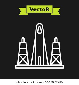 White line Rocket launch from the spaceport icon isolated on black background. Launch rocket in space.  Vector Illustration