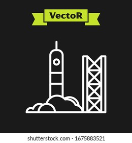 White line Rocket launch from the spaceport icon isolated on black background. Launch rocket in space.  Vector Illustration