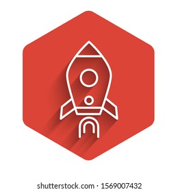 White line Rocket ship with fire icon isolated with long shadow. Space travel. Red hexagon button. Vector Illustration