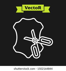 White line Scissors and leather icon isolated on black background. Tailor symbol. Cutting tool sign.  Vector Illustration