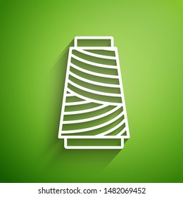 White line Sewing thread on spool icon isolated on green background. Yarn spool. Thread bobbin.  Vector Illustration