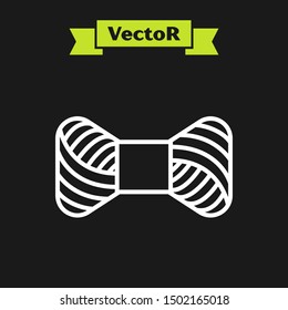 White line Sewing thread on spool icon isolated on black background. Yarn spool. Thread bobbin.  Vector Illustration