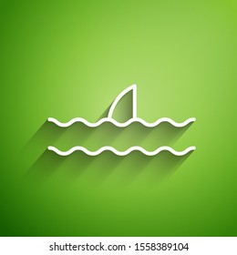 White line Shark fin in ocean wave icon isolated on green background.  Vector Illustration