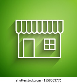 White line Shopping building or market store icon isolated on green background. Shop construction.  Vector Illustration