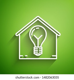 White line Smart house and light bulb icon isolated on green background.  Vector Illustration