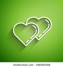 White line Two Linked Hearts icon isolated on green background. Romantic symbol linked, join, passion and wedding. Valentine day symbol.  Vector Illustration