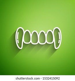 White line Vampire teeth icon isolated on green background. Happy Halloween party.  Vector Illustration