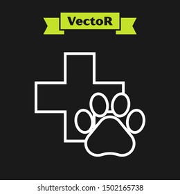 White line Veterinary clinic symbol icon isolated on black background. Cross hospital sign. A stylized paw print dog or cat. Pet First Aid sign.  Vector Illustration