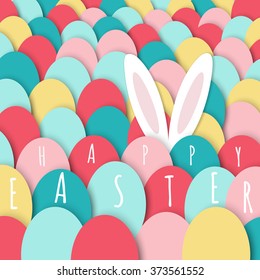 White long ears of bunny hiding behind bright colorful Easter eggs. Happy Easter greeting card	