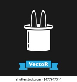 White Magician hat and rabbit ears icon isolated on black background. Magic trick. Mystery entertainment concept.  Vector Illustration