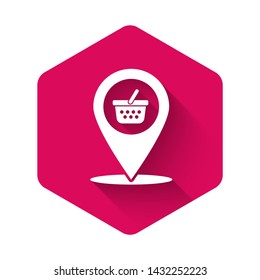 White Map pointer with shopping basket icon isolated with long shadow. Pin point shop and shopping. Supermarket basket symbol. Pink hexagon button. Vector Illustration