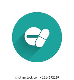 White Medicine pill or tablet icon isolated with long shadow. Capsule pill and drug sign. Pharmacy design. Green circle button. Vector Illustration