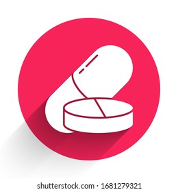 White Medicine pill or tablet icon isolated with long shadow. Capsule pill and drug sign. Pharmacy design. Red circle button. Vector Illustration