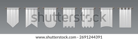 White medieval pennant set hanging on golden rods - pointed flag shapes, castle battlements, rounded bottoms and rectangular banners for heraldic display. Royal textile standards with decorative cuts.
