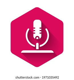 White Microphone icon isolated with long shadow. On air radio mic microphone. Speaker sign. Pink hexagon button. Vector