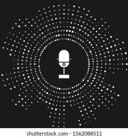 White Microphone icon isolated on grey background. On air radio mic microphone. Speaker sign. Abstract circle random dots. Vector Illustration