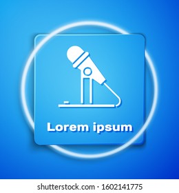 White Microphone icon isolated on blue background. On air radio mic microphone. Speaker sign. Blue square button. Vector Illustration