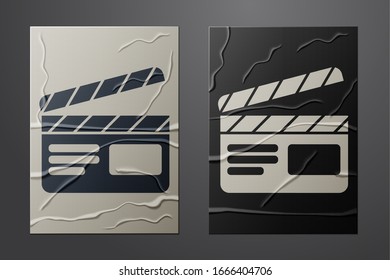 White Movie clapper icon isolated on crumpled paper background. Film clapper board. Clapperboard sign. Cinema production or media industry. Paper art style. Vector Illustration