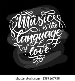 White "Music is the language of love"  hand drawn lettering phrase on chalk board background. Handwritten calligraphy design for greeting cards, posters, banners, cloth, textile, fabric. 