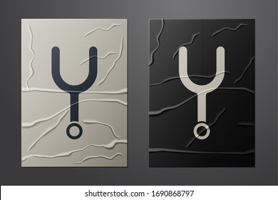 White Musical tuning fork for tuning musical instruments icon isolated on crumpled paper background. Paper art style. Vector Illustration