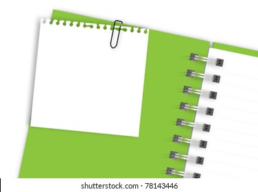 White note paper on green notebook