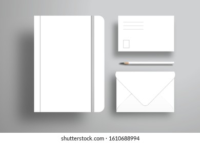 A white notebook with an elastic band, a postcard, an open envelope and a pencil. Realistic design for branding. Flat layout of white objects