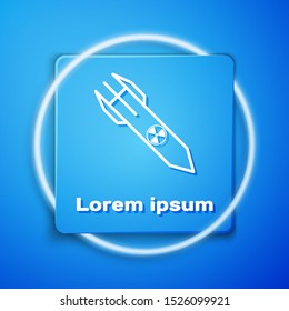 White Nuclear rocket icon isolated on blue background. Rocket bomb flies down. Blue square button. Vector Illustration