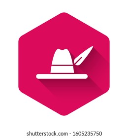 White Oktoberfest hat icon isolated with long shadow. Hunter hat with feather. German hat. Pink hexagon button. Vector Illustration