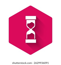 White Old hourglass with flowing sand icon isolated with long shadow. Sand clock sign. Business and time management concept. Pink hexagon button. Vector