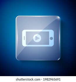 White Online play video icon isolated on blue background. Smartphone and film strip with play sign. Square glass panels. Vector Illustration