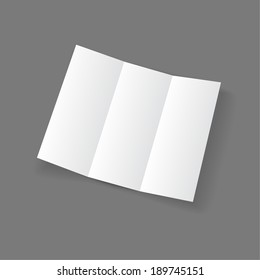 White open lying blank trifold paper brochure on gray background. 