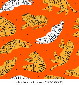 White and orange tigers are lying in various poses. Hand drawn vector seamless pattern. Red background. Perfect for printing
